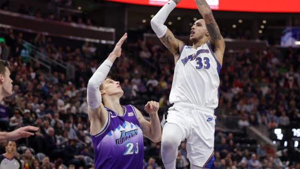 Dec 22, 2022; Salt Lake City, Utah, USA; Washington Wizards forward Kyle Kuzma (33) shoots the ball over Utah Jazz forward Lauri Markkanen (23) during the second half at Vivint Arena. Mandatory Credit: Chris Nicoll-USA TODAY Sports